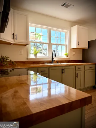 a kitchen with stainless steel appliances granite countertop a sink counter space and a window