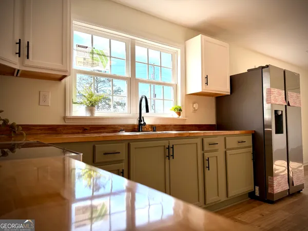 a kitchen with stainless steel appliances granite countertop a refrigerator and a sink
