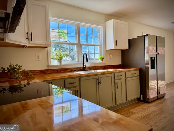 a kitchen with stainless steel appliances granite countertop a sink a stove and refrigerator