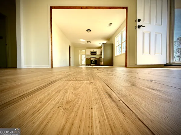 a view of a room with wooden floor