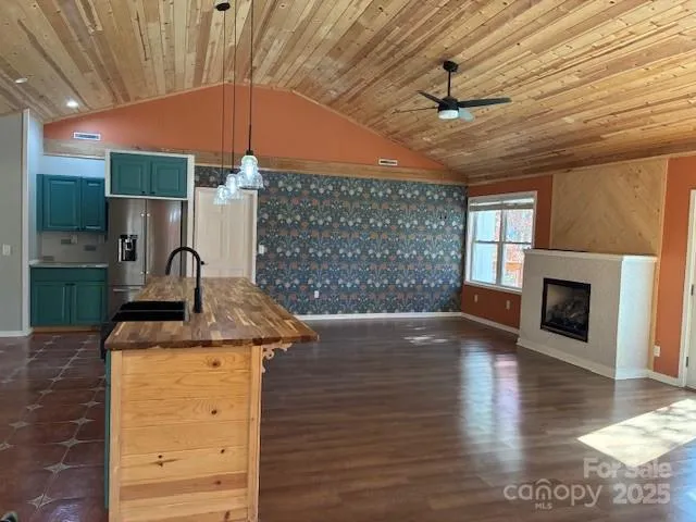 a kitchen with a stove and a wooden floor