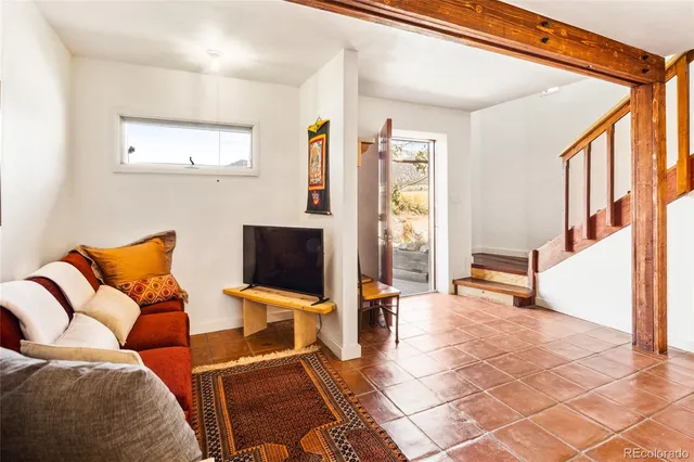 a view of an entryway with wooden floor and a livingroom view