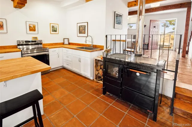 a kitchen with stainless steel appliances granite countertop a stove and a refrigerator