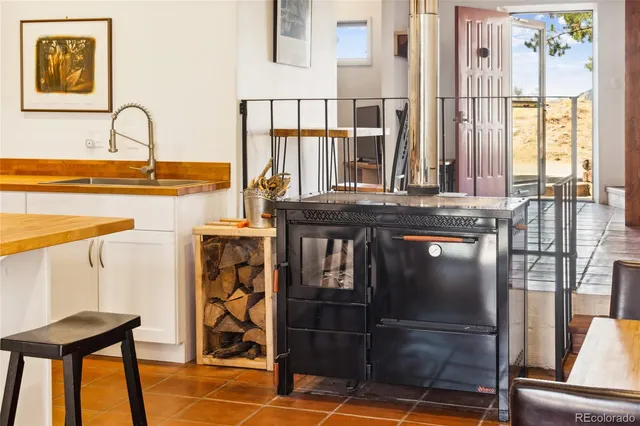 a view of a patio with table and chairs with wooden floor and fence