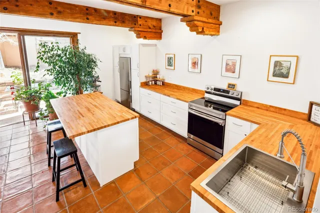 a view of a dining room with furniture and a potted plant