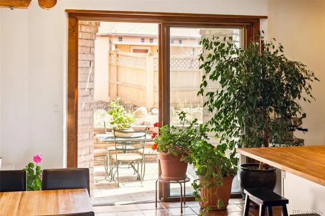 a view of a porch with chairs and potted plants