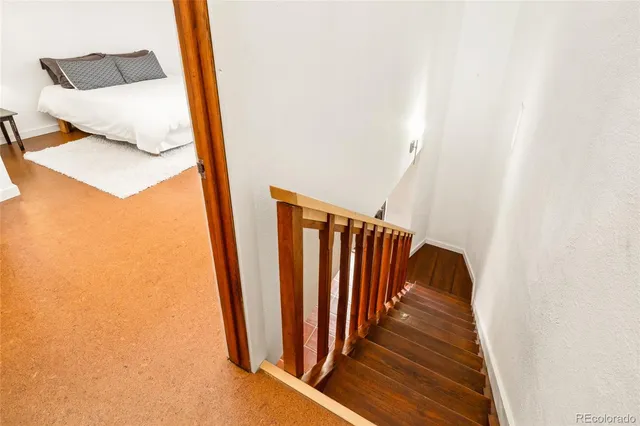 a large bed sitting in a bedroom next to a cabinet