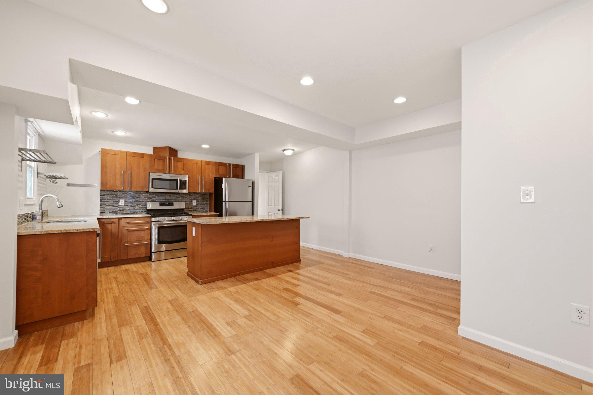 737 Morton Street Northwest Washington, DC 20010 - Photo 25 of 36 Modern kitchen with warm wood accents.
