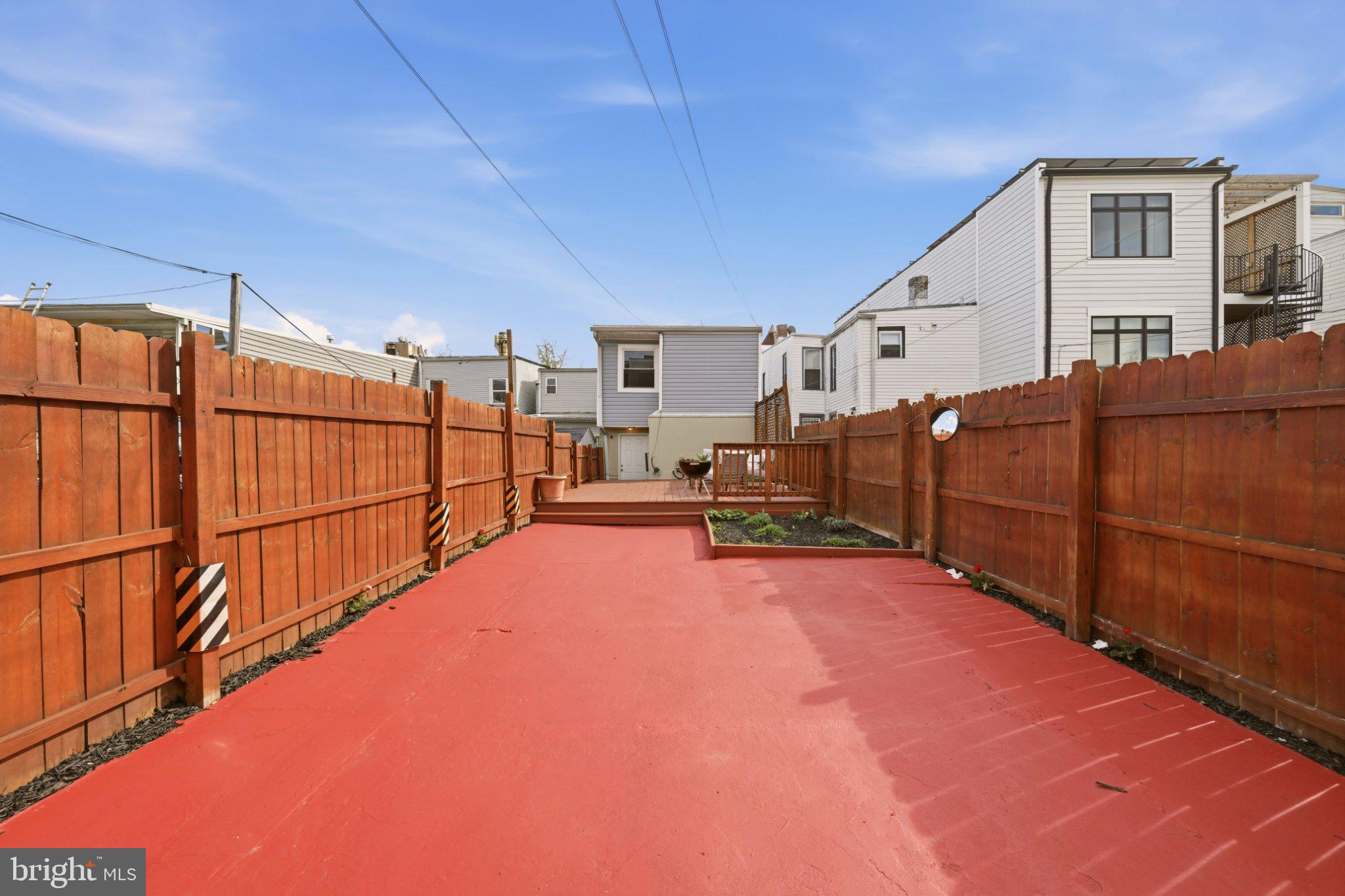 737 Morton Street Northwest Washington, DC 20010 - Photo 35 of 36 Spacious backyard with vibrant red patio.