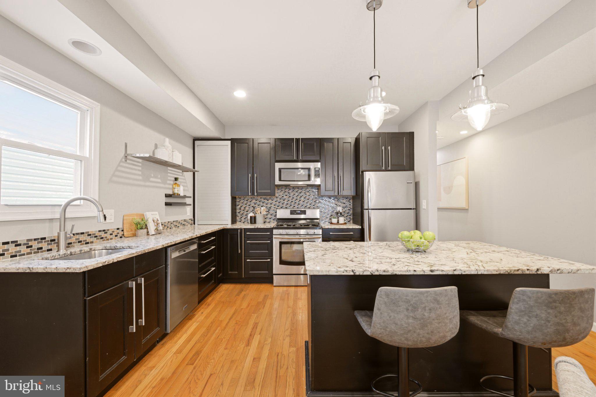 737 Morton Street Northwest Washington, DC 20010 - Photo 10 of 36 Sleek modern kitchen with island charm.