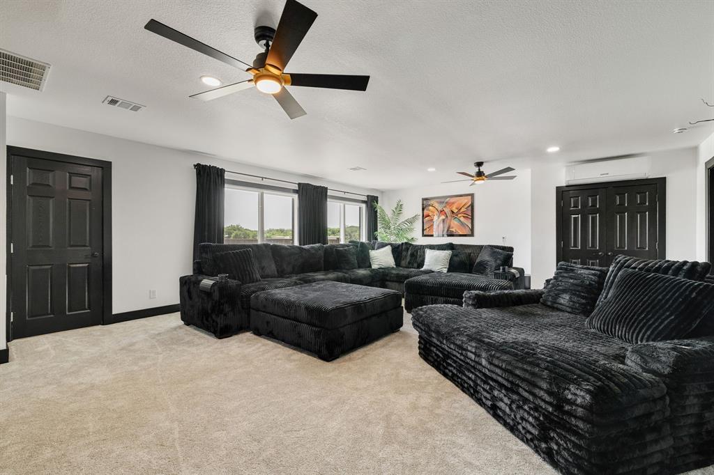 12240 Wellington Road Ponder, TX 76259 - Photo 19 of 40 Spacious interior room featuring light-toned carpeting and white walls