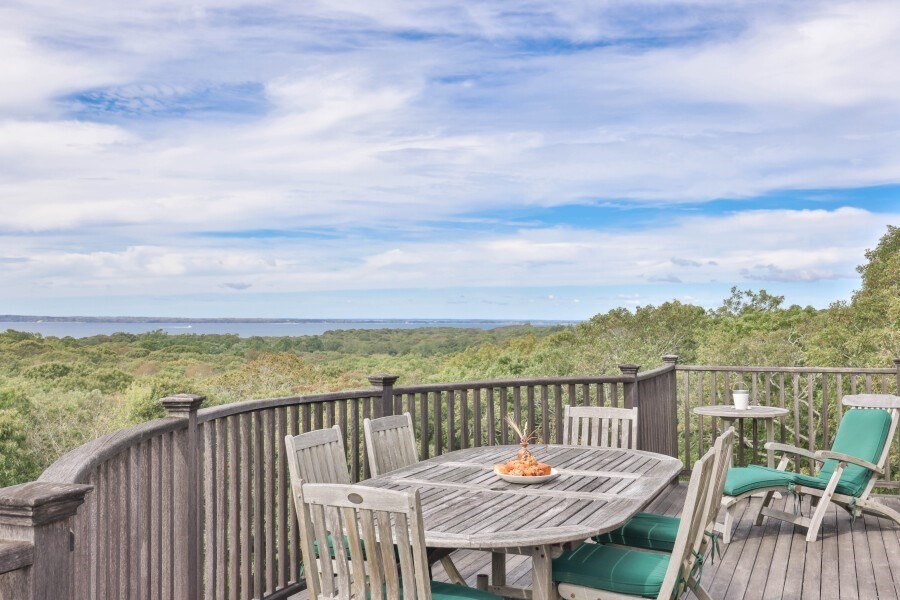 97 Longview Road West Tisbury, MA 02568 - Photo 14 of 42 a view of a balcony with wooden chairs with wooden floor