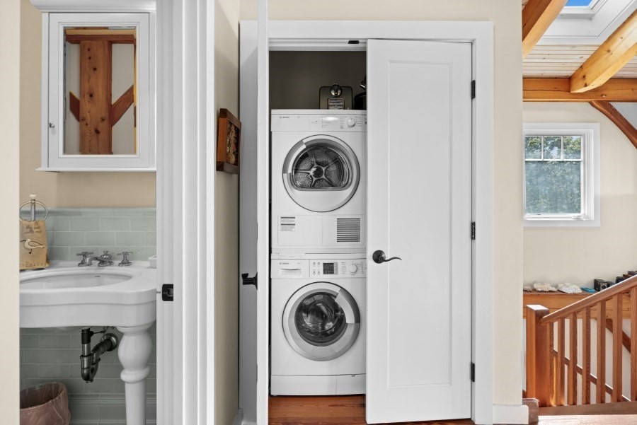 97 Longview Road West Tisbury, MA 02568 - Photo 21 of 42 a utility room with dryer washer and a view of bedroom