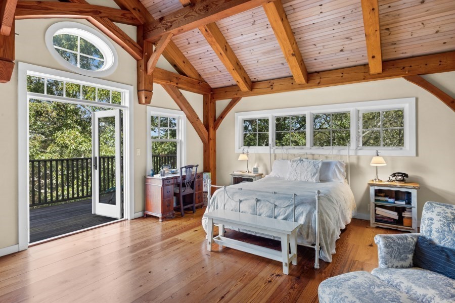 97 Longview Road West Tisbury, MA 02568 - Photo 22 of 42 a bedroom with a bed and wooden floor