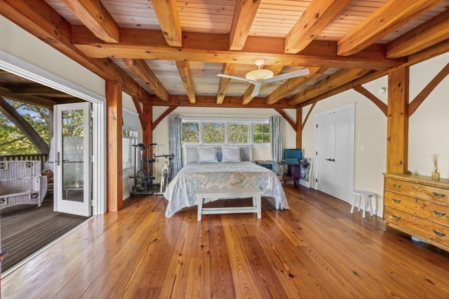 97 Longview Road West Tisbury, MA 02568 - Photo 34 of 42 a bedroom with a bed and wooden floor