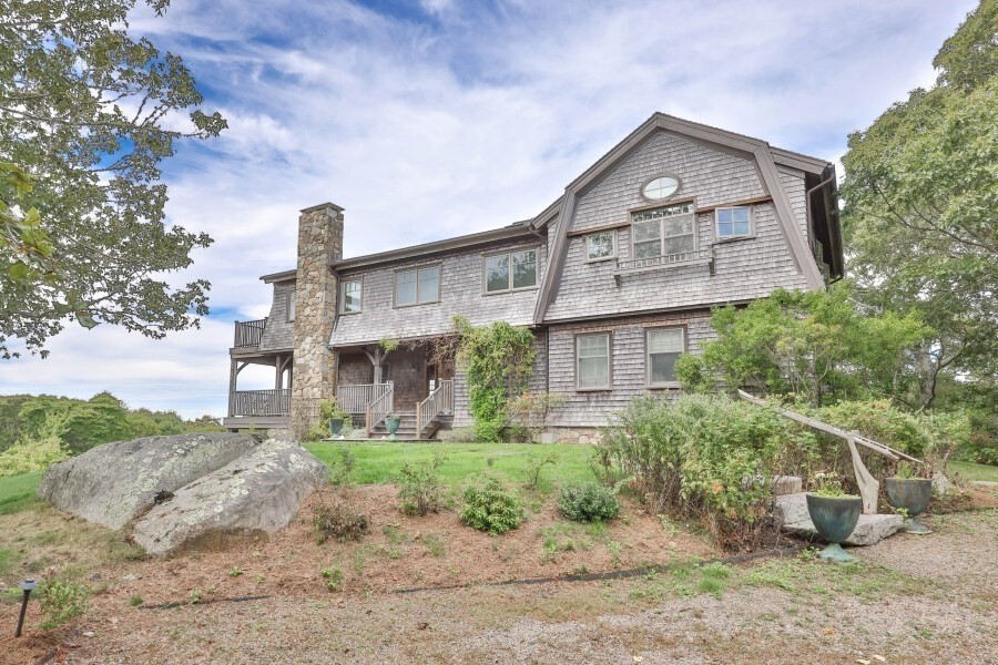 97 Longview Road West Tisbury, MA 02568 - Photo 40 of 42 a front view of a house with a yard and garage