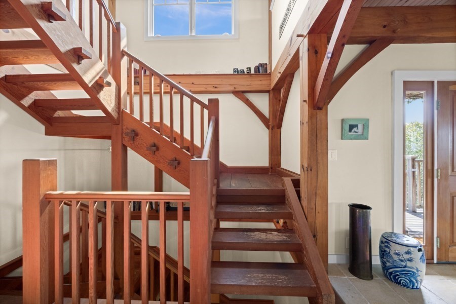 97 Longview Road West Tisbury, MA 02568 - Photo 8 of 42 a view of staircase with lots of frames on wall and a window