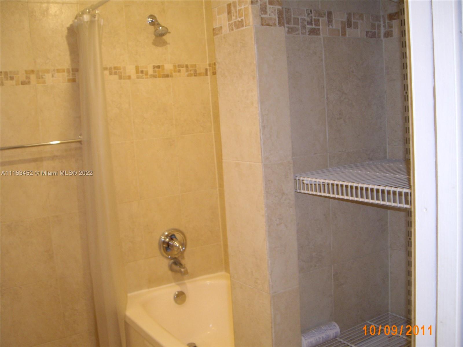 6709 North Kendall Drive, Unit 219 Pinecrest, FL 33156 - Photo 11 of 17 a bathroom with a white bath tub
