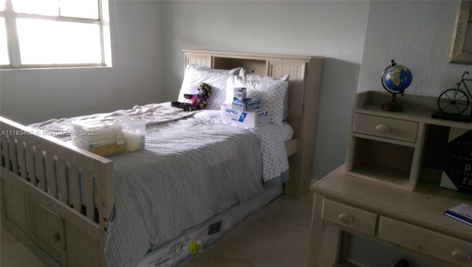 6709 North Kendall Drive, Unit 219 Pinecrest, FL 33156 - Photo 14 of 17 a bedroom with a bed and a tv