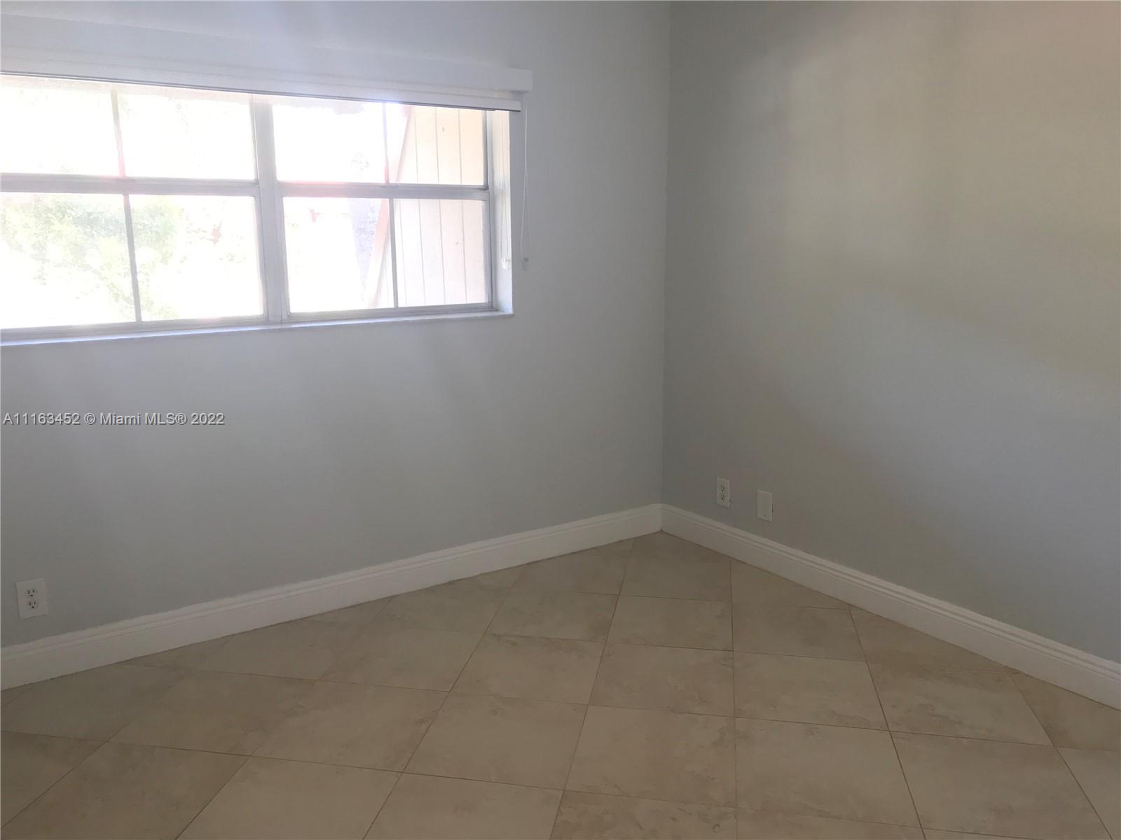 6709 North Kendall Drive, Unit 219 Pinecrest, FL 33156 - Photo 15 of 17 an empty room with a window