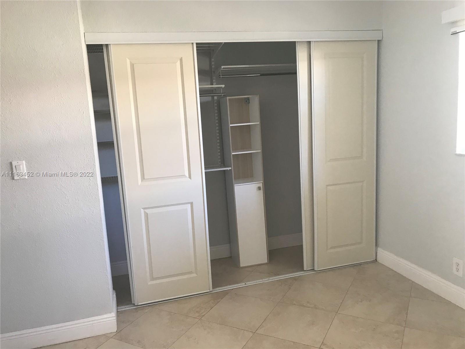 6709 North Kendall Drive, Unit 219 Pinecrest, FL 33156 - Photo 16 of 17 an empty room with closet and mirror