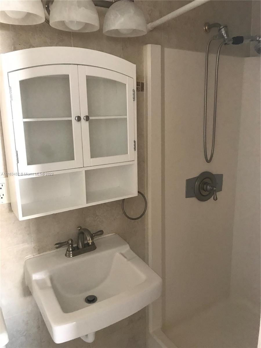 6709 North Kendall Drive, Unit 219 Pinecrest, FL 33156 - Photo 17 of 17 a bathroom with a sink and a mirror