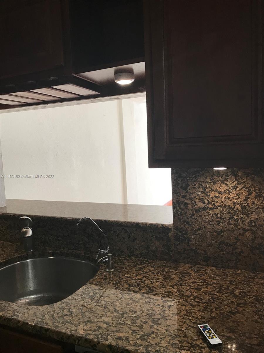 6709 North Kendall Drive, Unit 219 Pinecrest, FL 33156 - Photo 2 of 17 a kitchen with a sink and a refrigerator