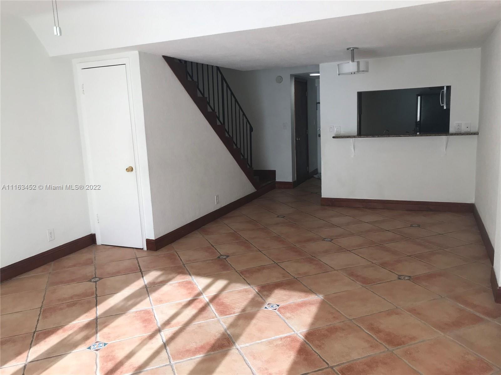 6709 North Kendall Drive, Unit 219 Pinecrest, FL 33156 - Photo 3 of 17 a view of entryway with stairs and a microwave