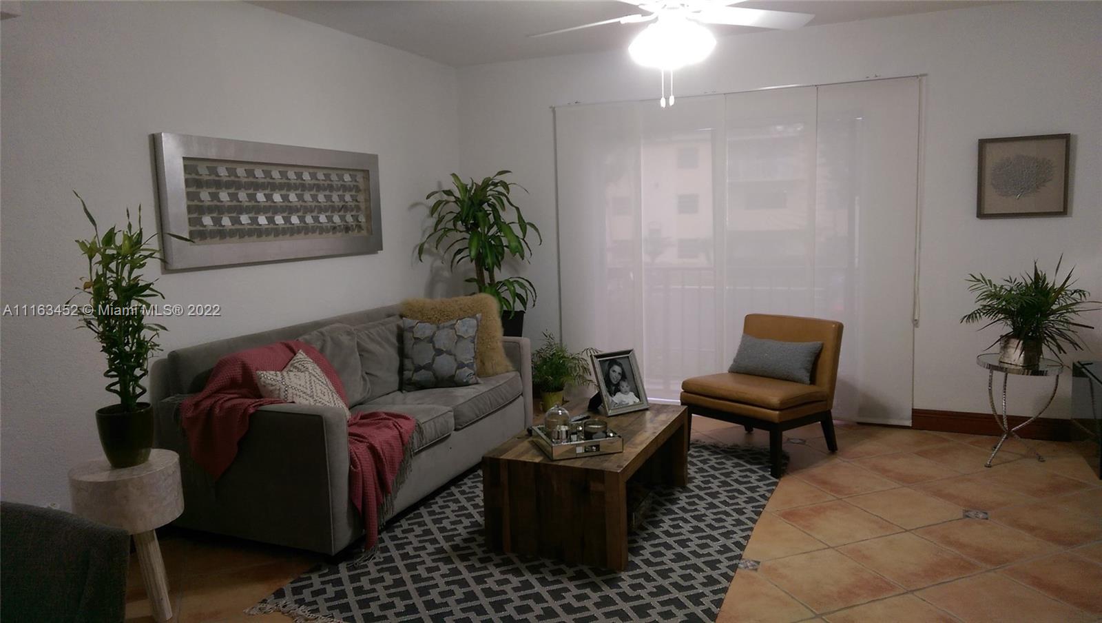 6709 North Kendall Drive, Unit 219 Pinecrest, FL 33156 - Photo 6 of 17 a living room with furniture potted plant and a lamp
