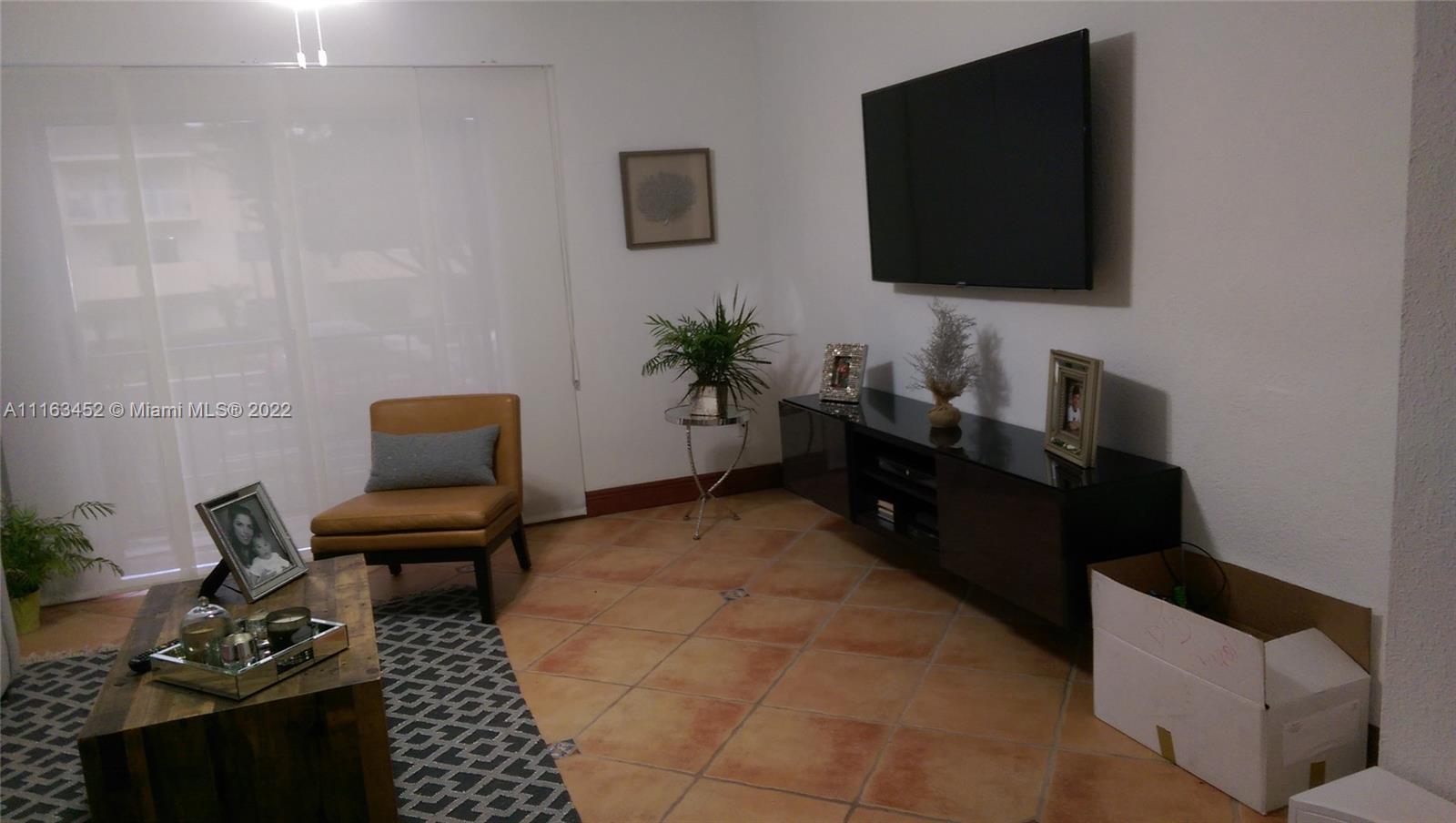 6709 North Kendall Drive, Unit 219 Pinecrest, FL 33156 - Photo 7 of 17 a living room with furniture and a flat screen tv