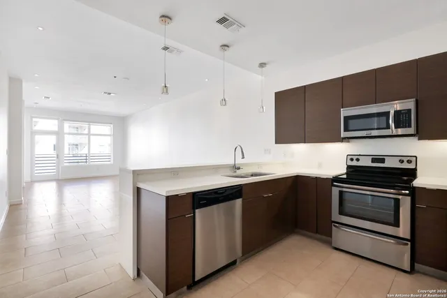 a kitchen with a sink and stainless steel appliances