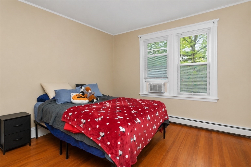 8 Colliston Road Boston, MA 02135 - Photo 17 of 40 a bedroom with a bed and a window