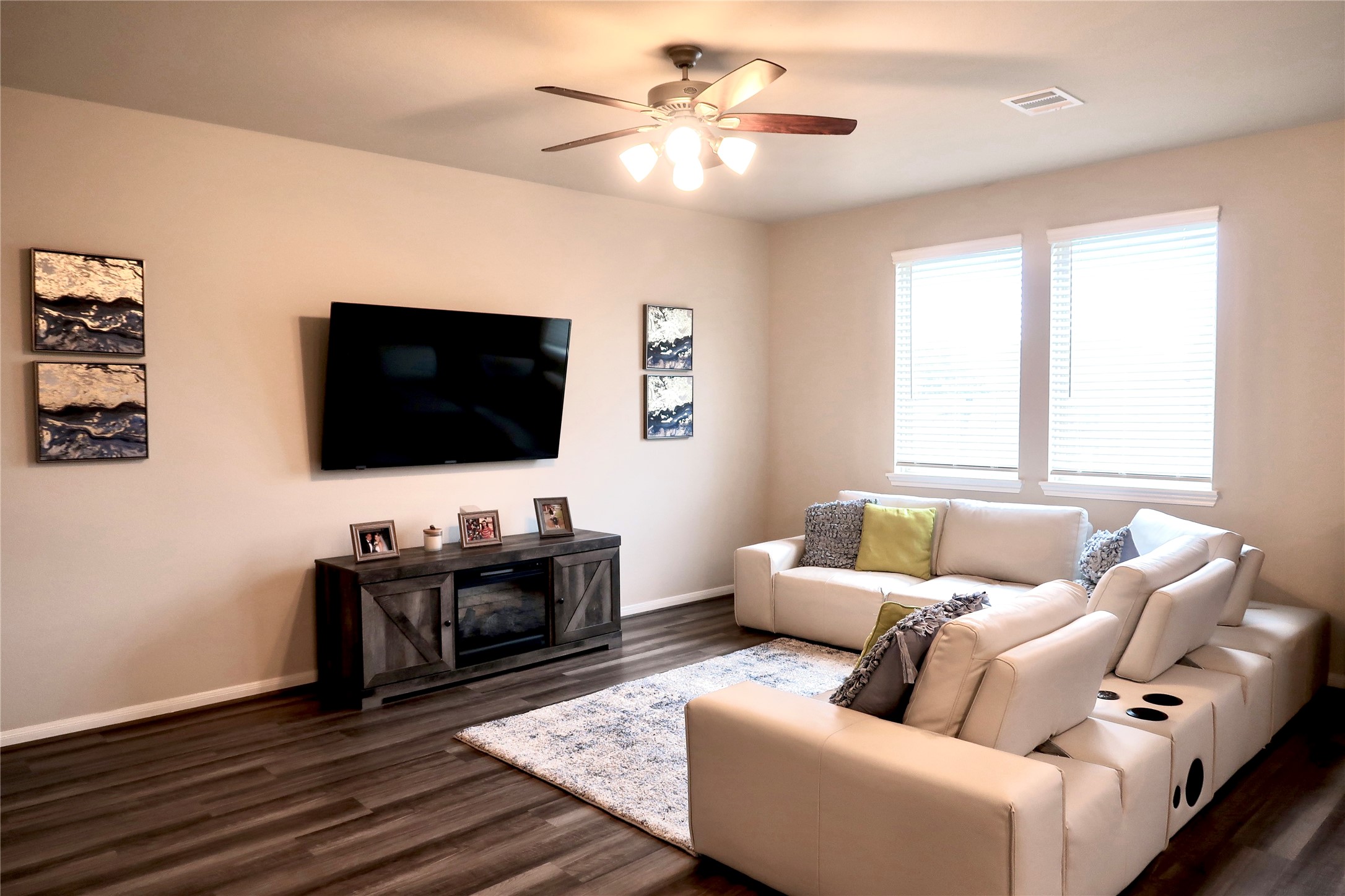 9850 Copper Ranch Trail Richmond, TX 77406 - Photo 5 of 24 Connected Living room with Electric fireplace, leather sofa, and TV. Ready to go for family time!