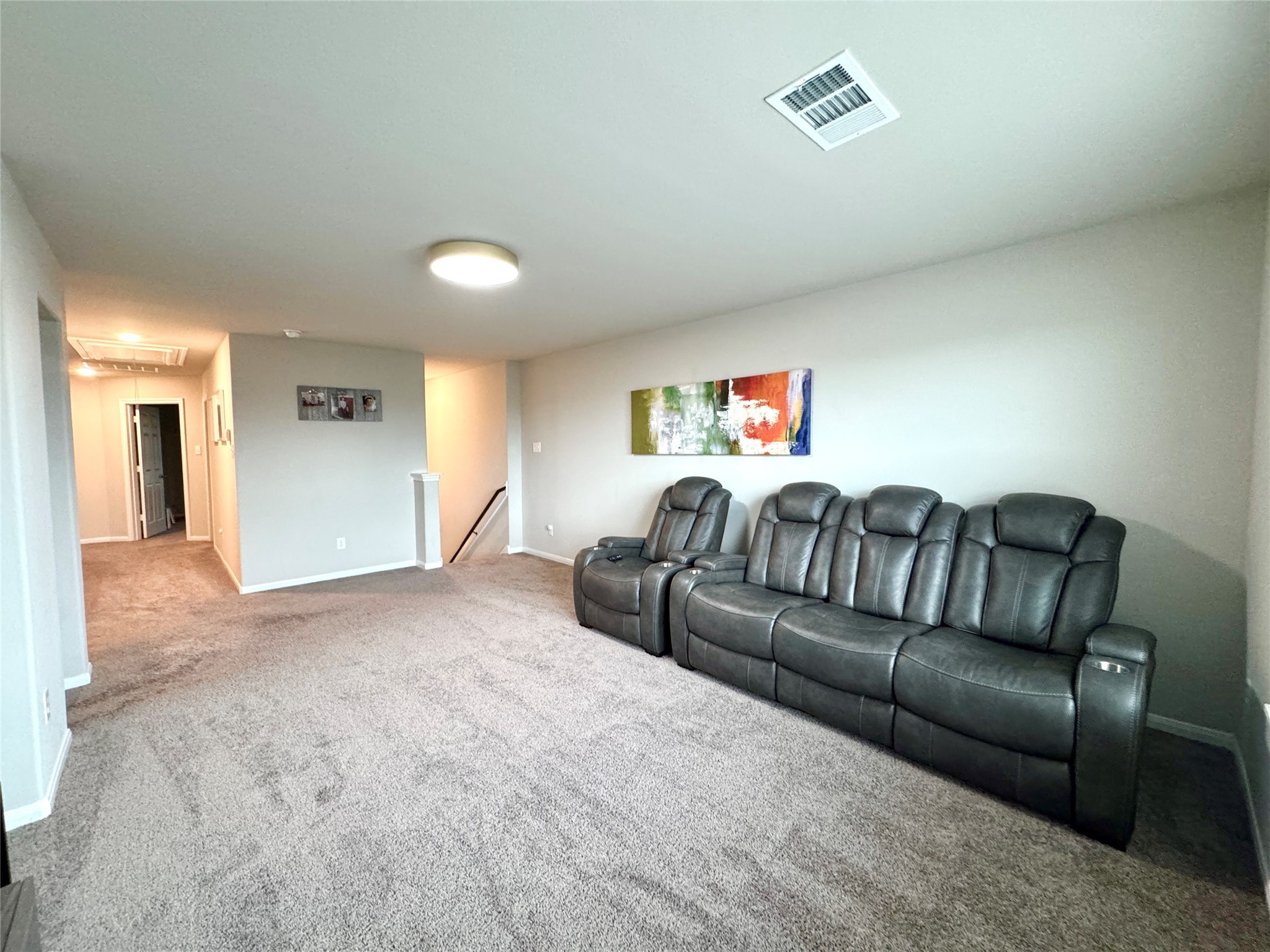 9850 Copper Ranch Trail Richmond, TX 77406 - Photo 9 of 24 Upstairs living room with leather sofa chairs and TV