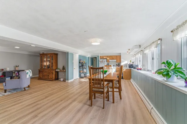 a dining room with furniture and wooden floor