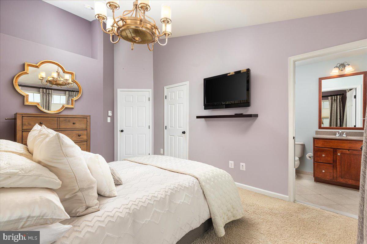 25436 South Riding Boulevard, Unit 2H Chantilly, VA 20152 - Photo 13 of 26 a bedroom with a bed and a television