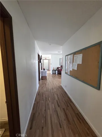 a view of a living room with furniture and wooden floor