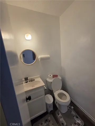 a bathroom with a toilet a sink and a mirror