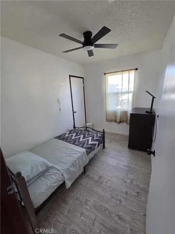 a bedroom with bed and window