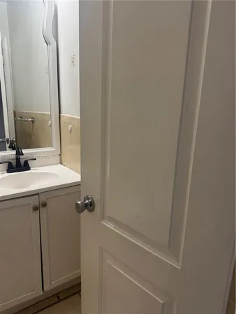 a bathroom with a sink a mirror and shower