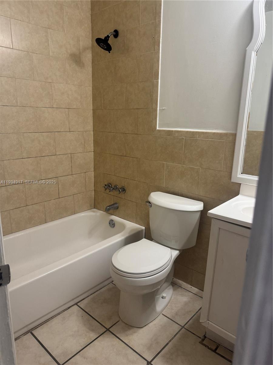 1550 West 7th Court, Unit 23 Hialeah, FL 33010 - Photo 5 of 8 a white toilet sitting next to a bath tub