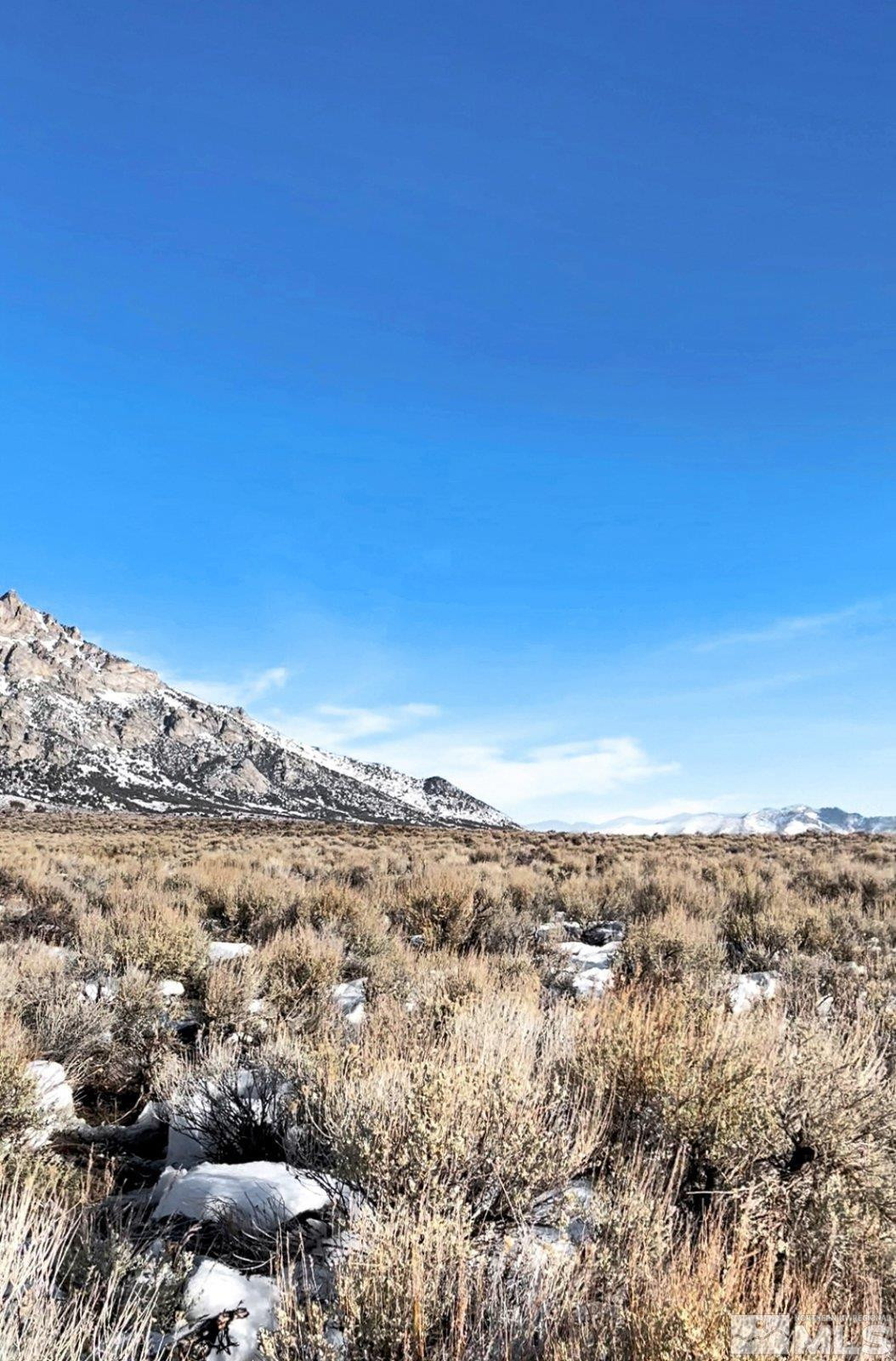 10873 Ruby Valley Road Spring Creek, NV 89815 - Photo 13 of 28 a view of a large building with mountains in the background