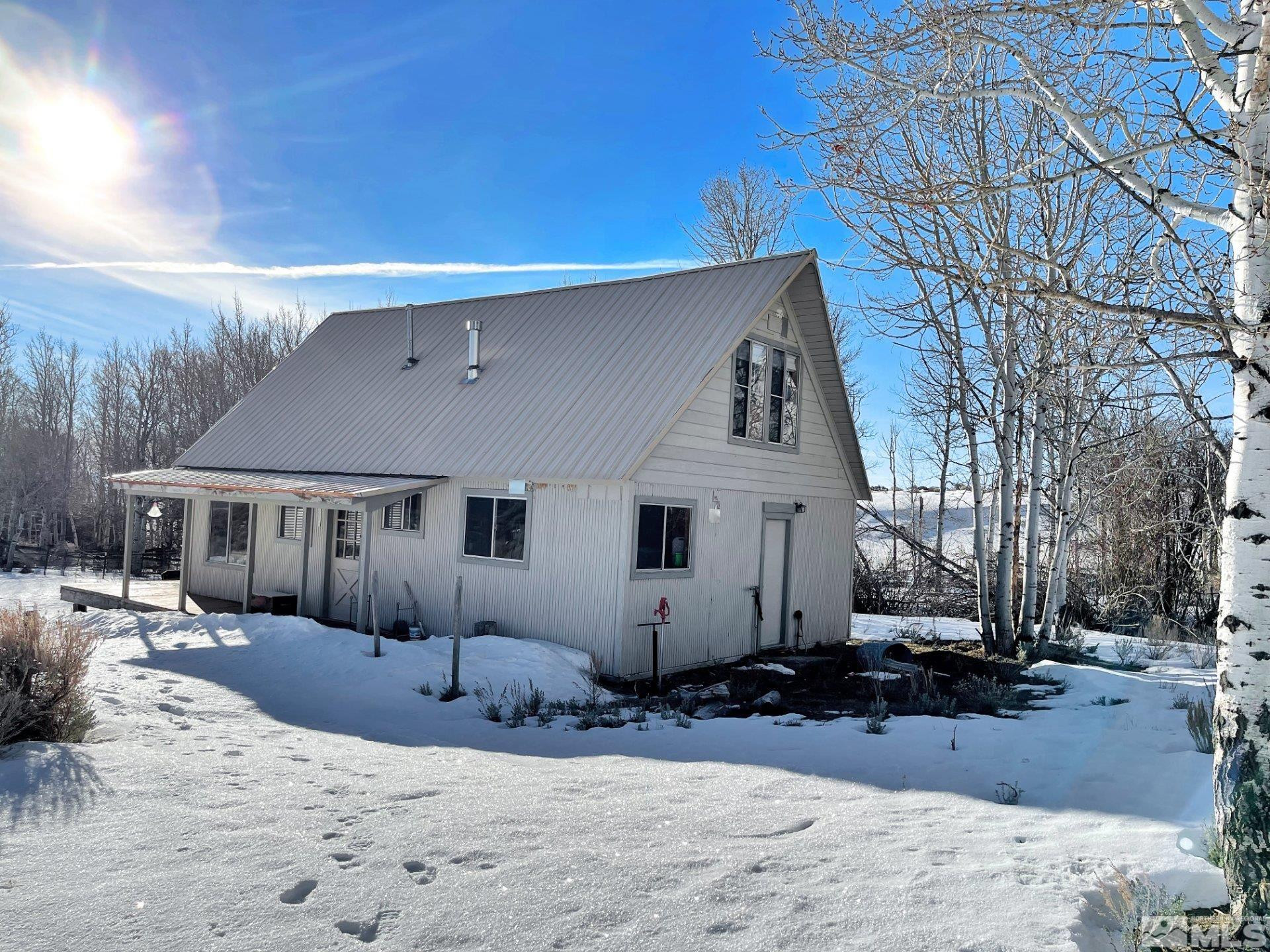 10873 Ruby Valley Road Spring Creek, NV 89815 - Photo 15 of 28 a view of a house with a yard covered in snow