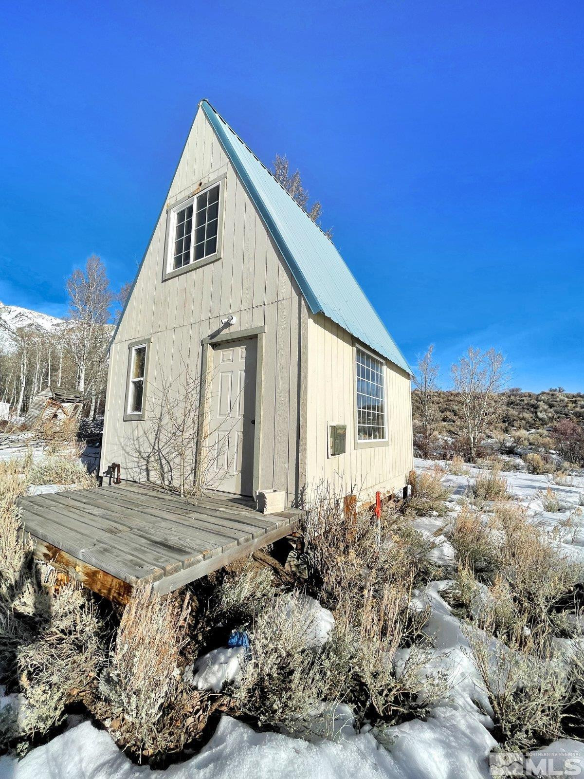 10873 Ruby Valley Road Spring Creek, NV 89815 - Photo 16 of 28 a view of a house with a wooden floor and a yard