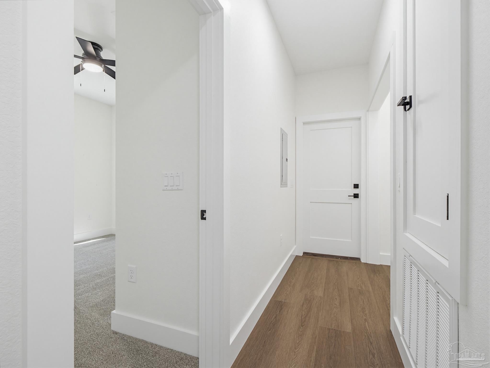 5724 Riviera Drive Milton, FL 32583 - Photo 35 of 52 a view of a room with wooden floor and a hallway