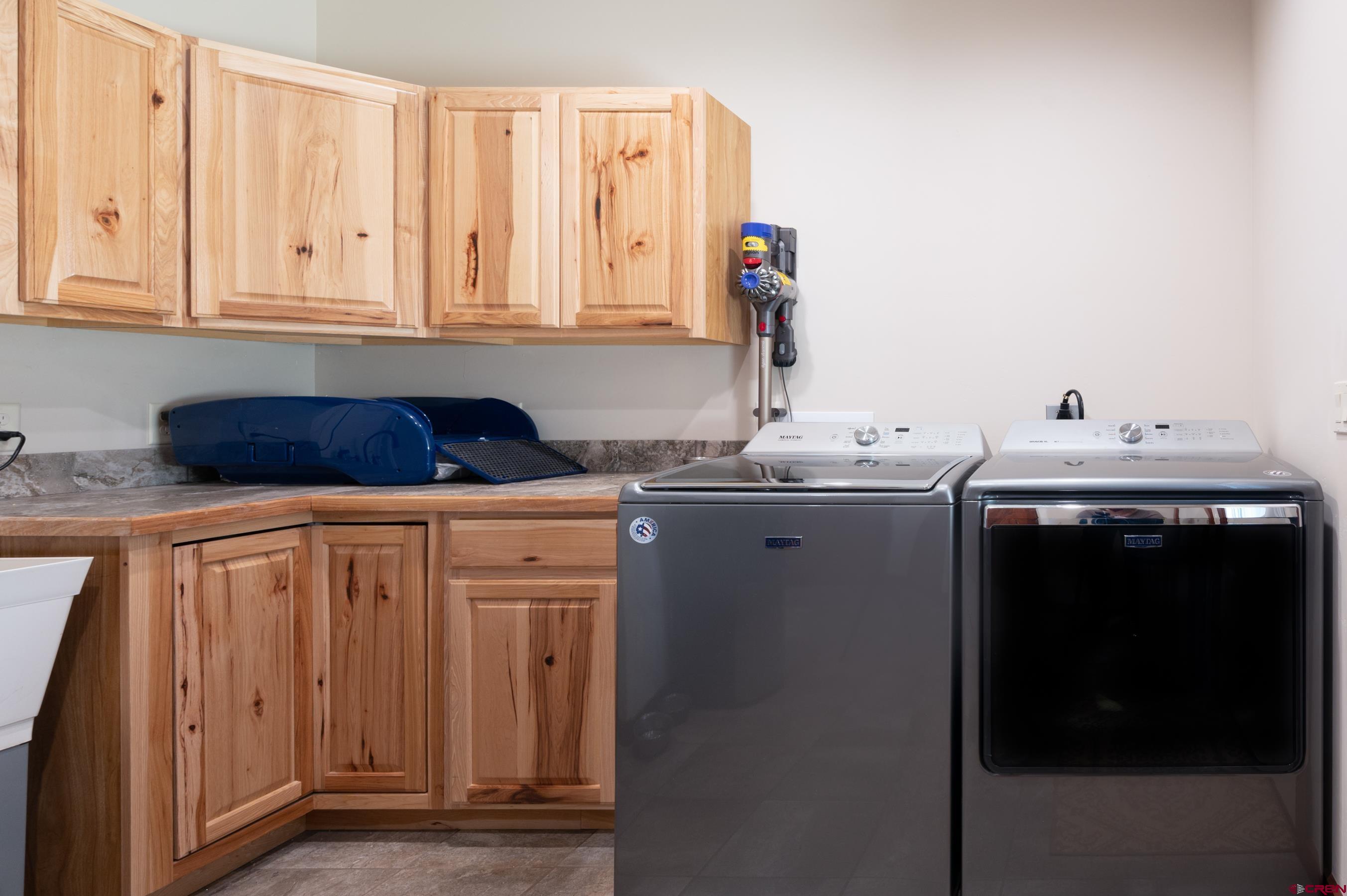 180 Ridge Road Durango, CO 81303 - Photo 12 of 35 a utility room with stainless steel appliances white cabinets and a sink