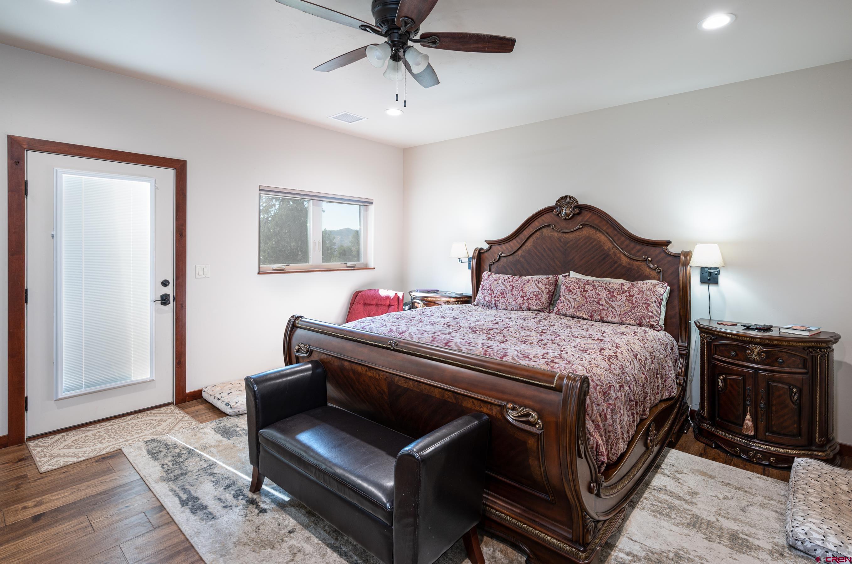 180 Ridge Road Durango, CO 81303 - Photo 14 of 35 a bedroom with a bed and wooden floor