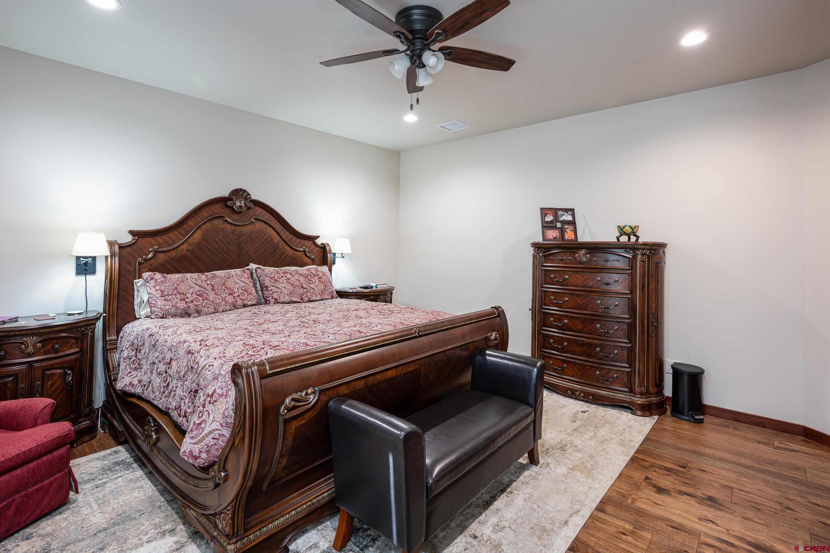180 Ridge Road Durango, CO 81303 - Photo 15 of 35 a bedroom with a bed and a chandelier