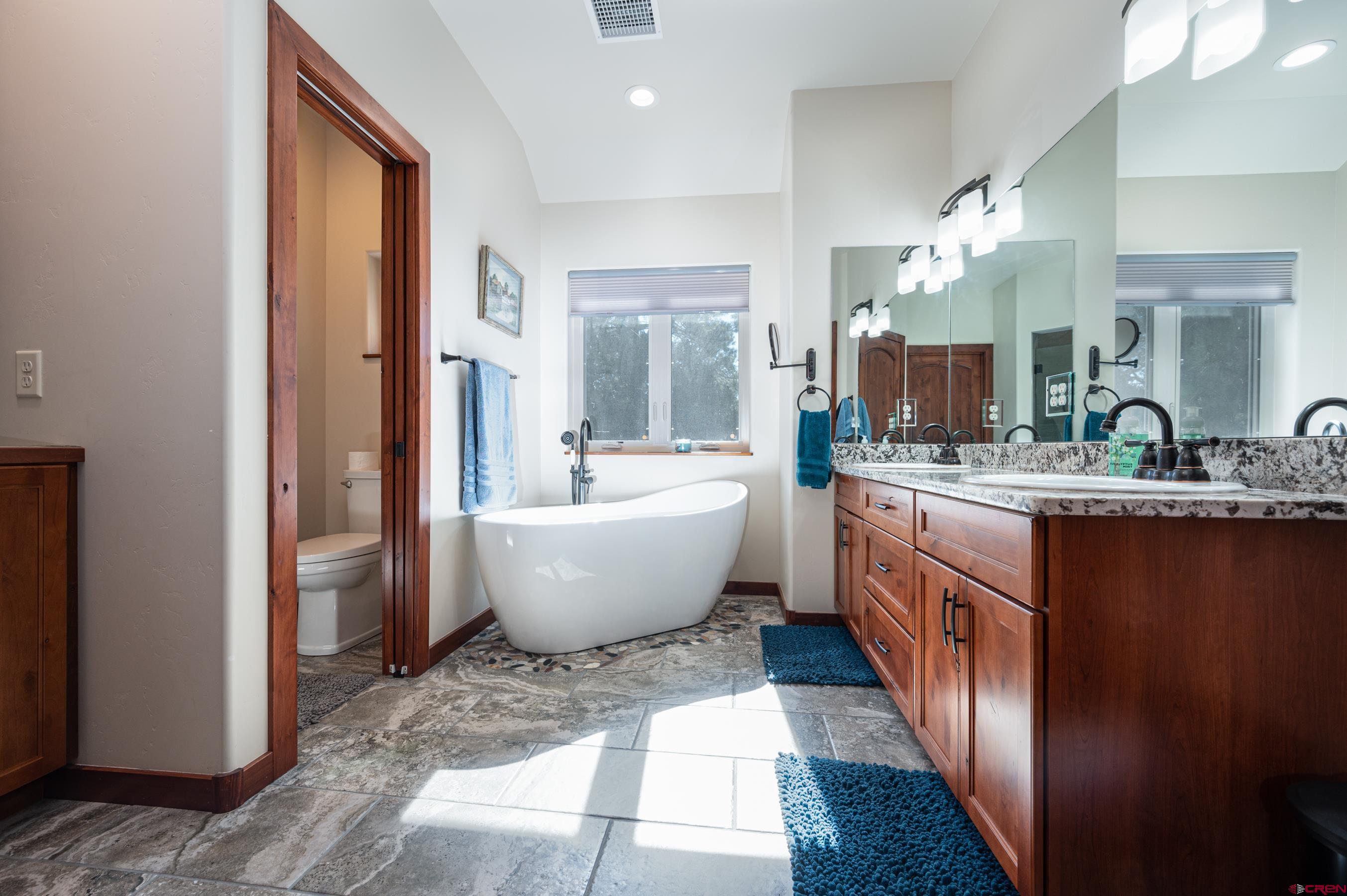 180 Ridge Road Durango, CO 81303 - Photo 18 of 35 a large spacious bathroom with a double vanity sink a mirror and a bathtub