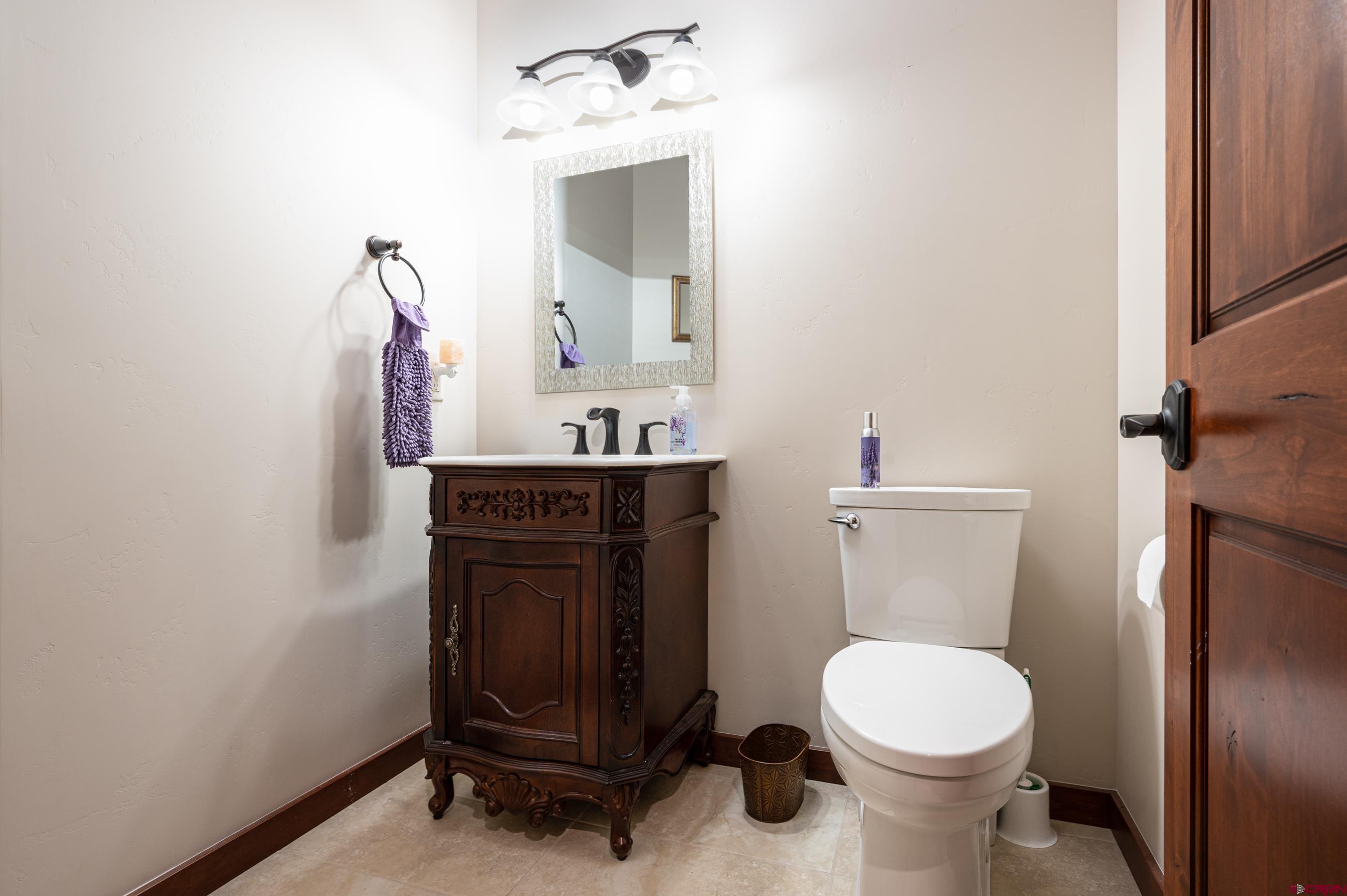 180 Ridge Road Durango, CO 81303 - Photo 20 of 35 a bathroom with a toilet a sink and mirror
